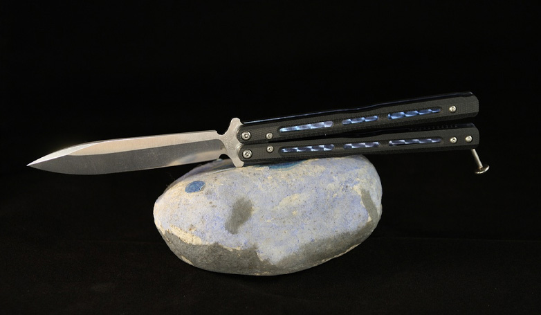 The Butterfly Knife (Balisong) over the rock