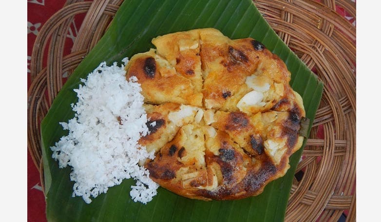 A newly cooked Bibingka with salted egg on top and coconut